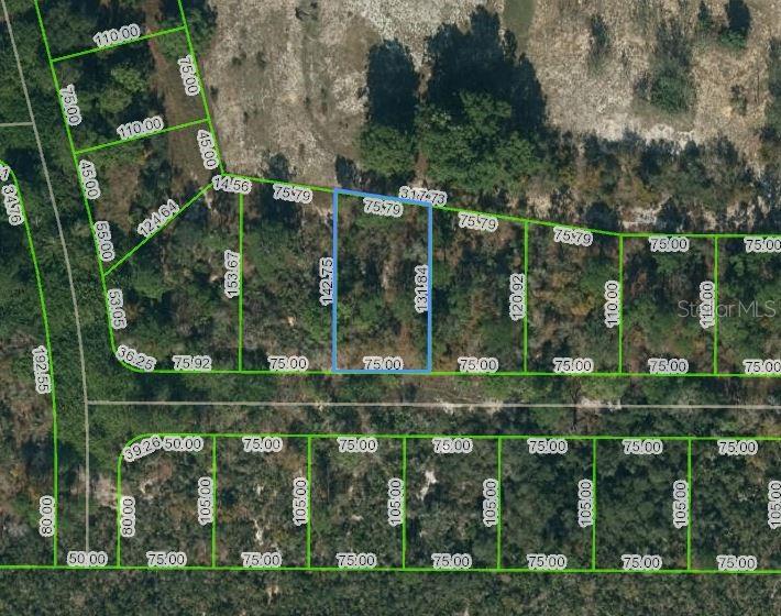 an aerial view of a houses with a yard