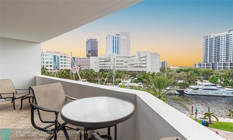 a view of a balcony with table and chairs