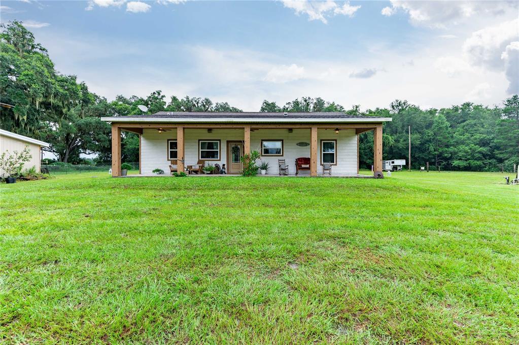 a view of a house with backyard porch and sitting area