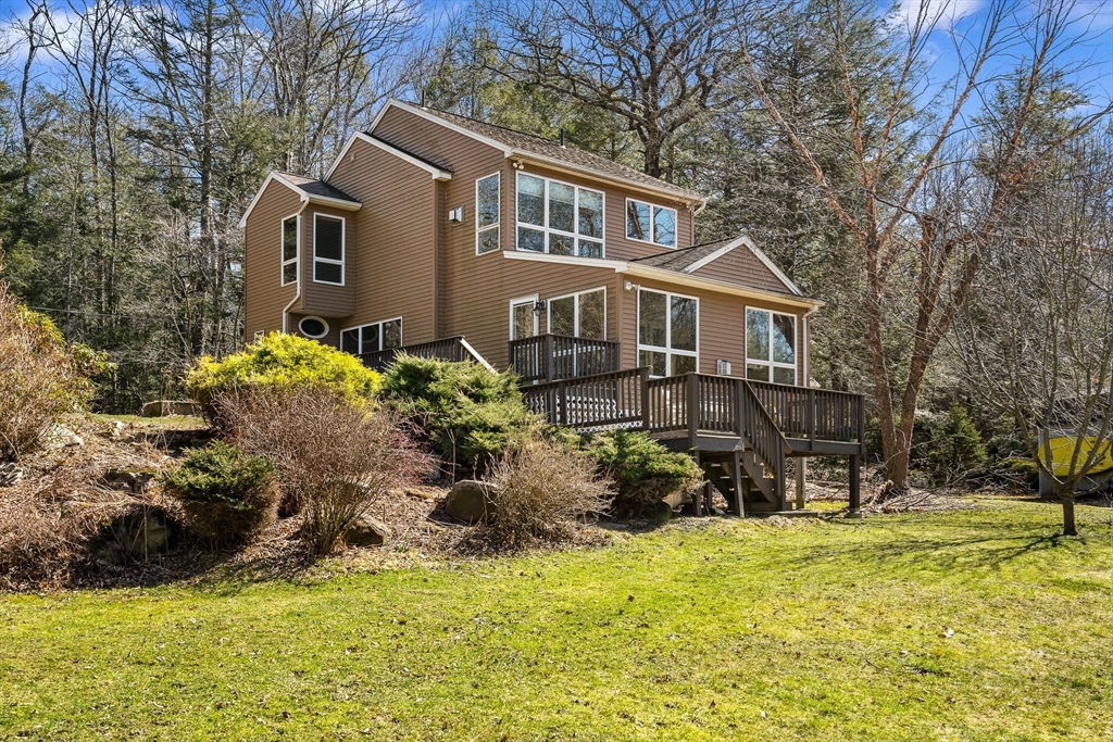 a front view of house with yard and trees around