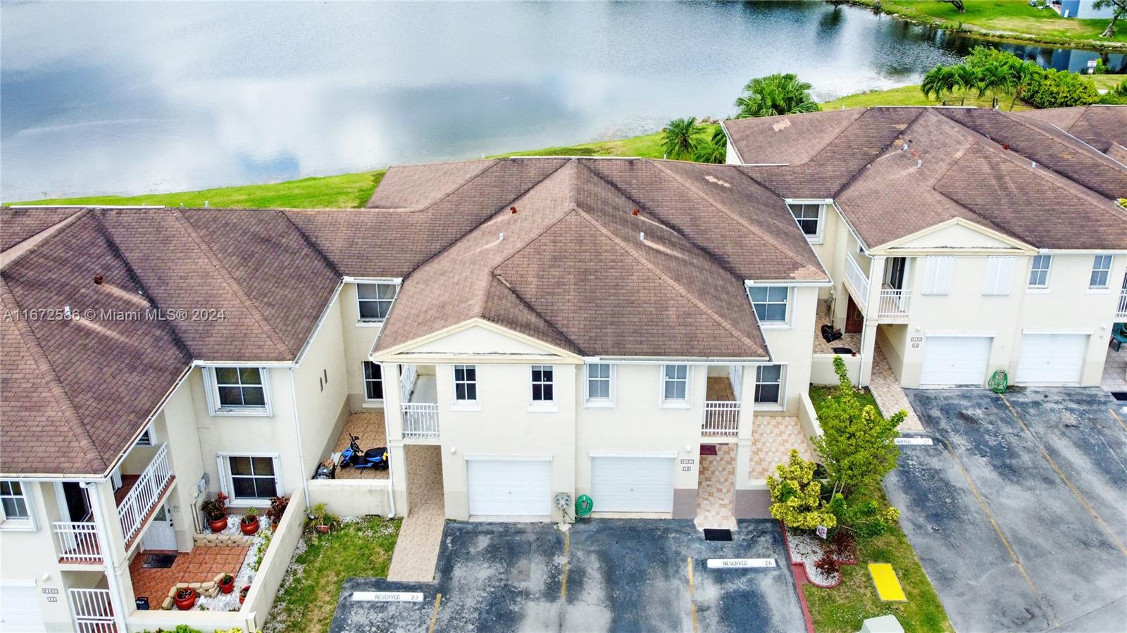 a aerial view of a house with a yard and potted plants