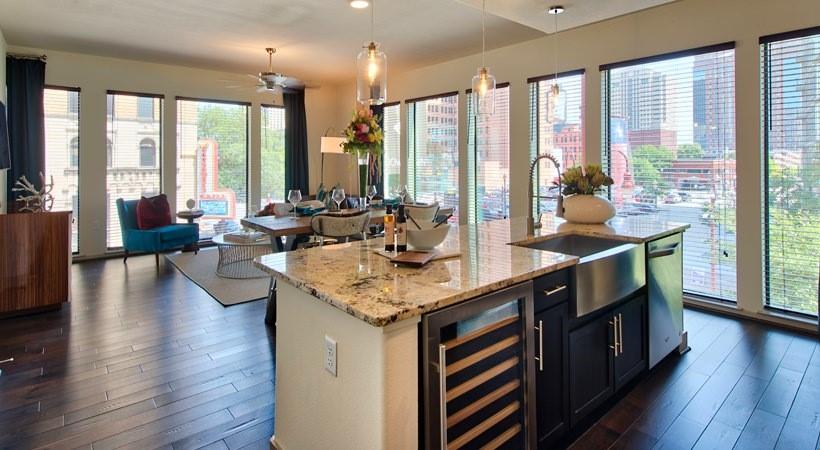 a kitchen with stainless steel appliances granite countertop sink stove and wooden floor