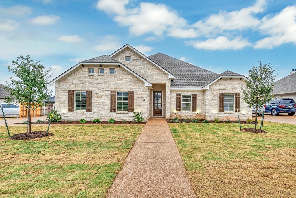 a front view of a house with a yard