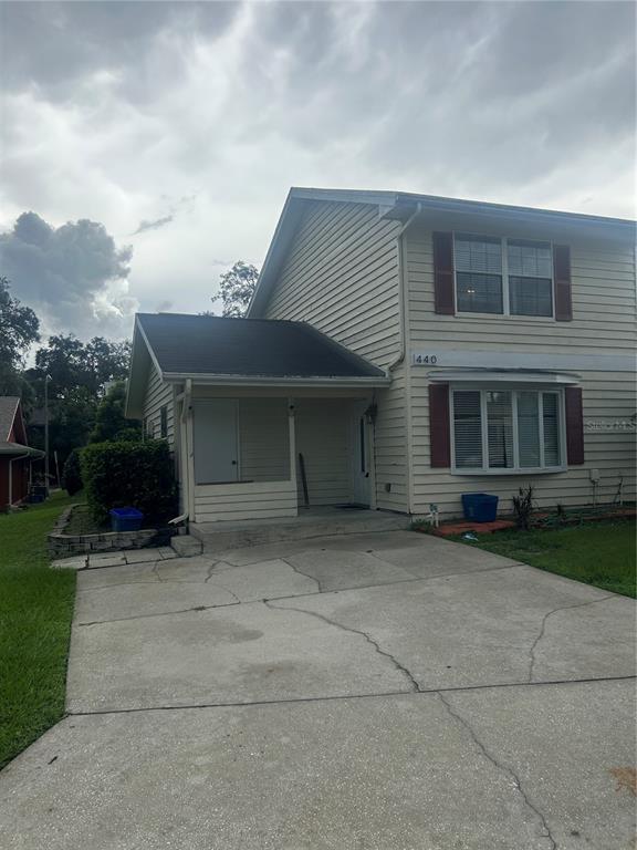 a front view of a house with a yard and a garage