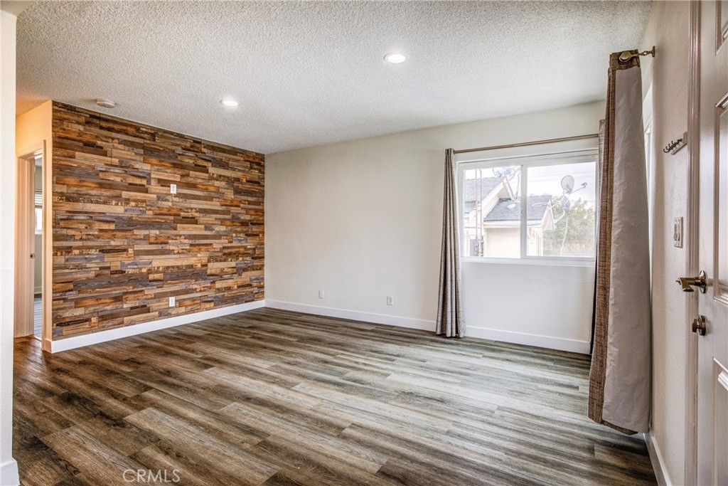 an empty room with wooden floor and a window