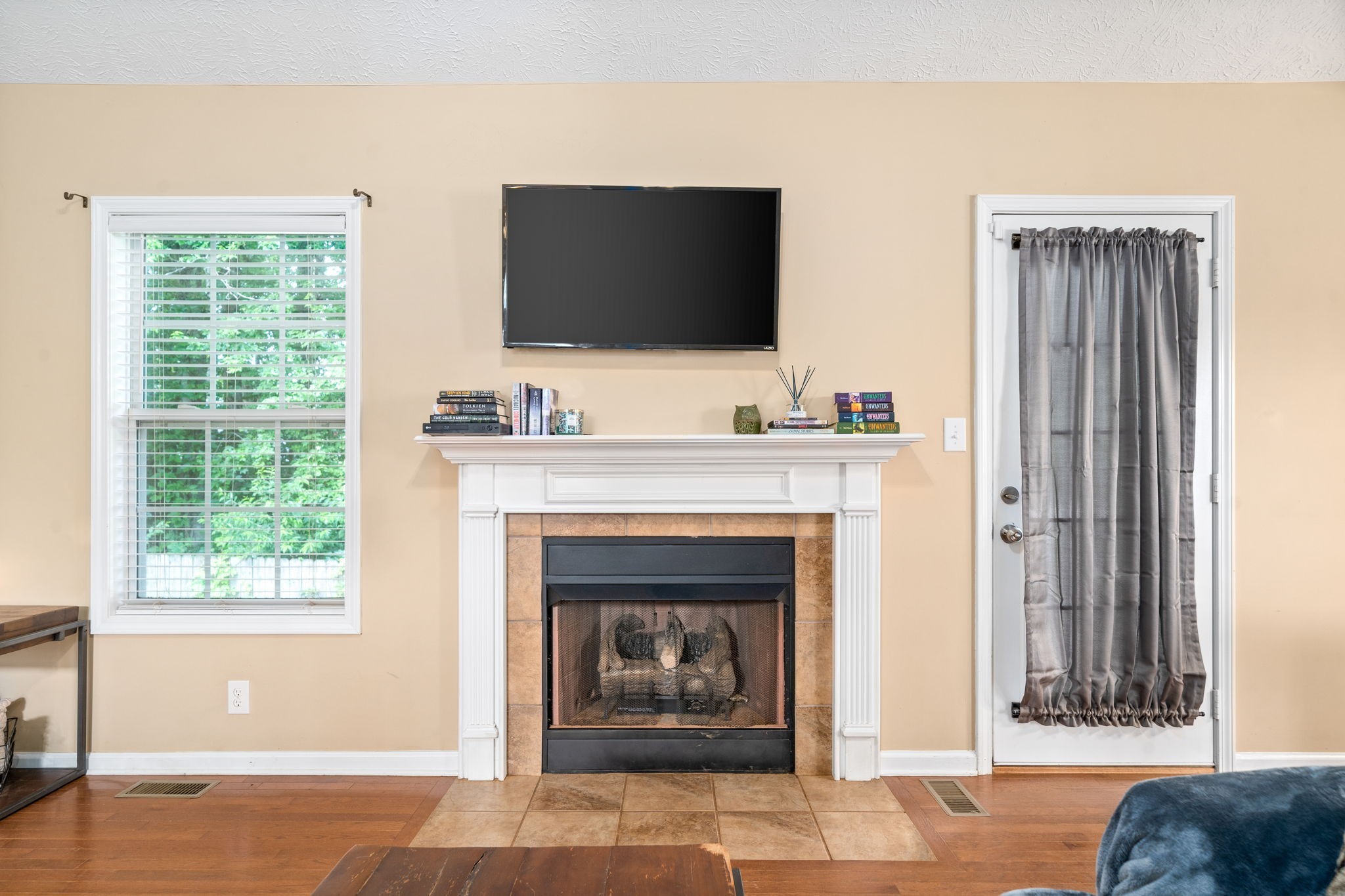 a living room with a fireplace and a flat screen tv