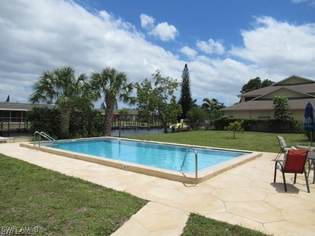 a view of a swimming pool with a yard