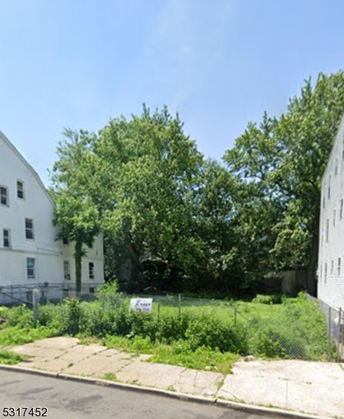 a backyard of a house with lots of green space and plants