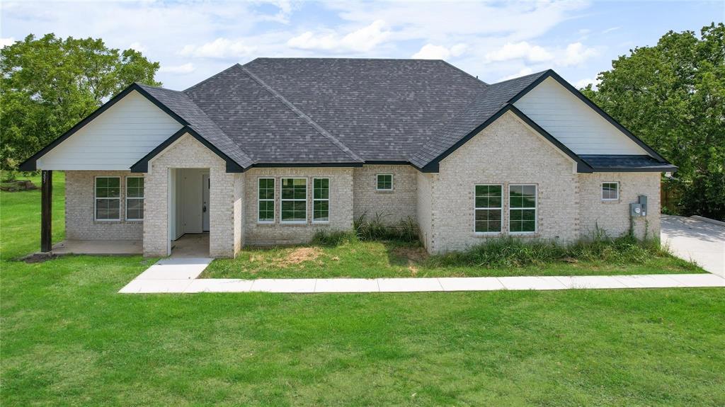 a front view of a house with a garden