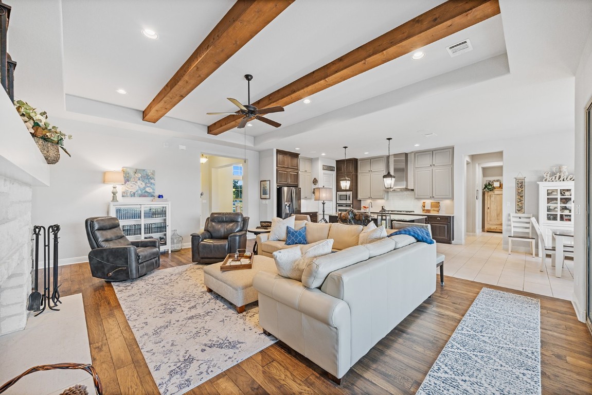 a living room with furniture kitchen view and a table