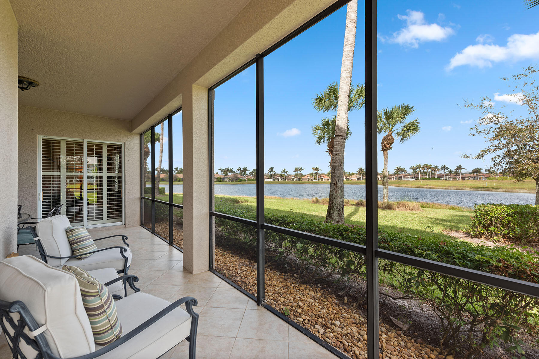 a view of a balcony with lake view and a floor to ceiling window next to a patio