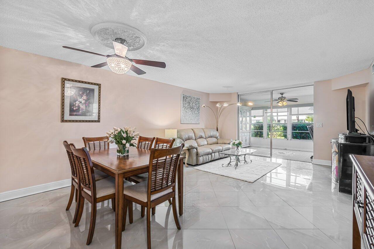 a view of a dining room with furniture wooden floor and chandelier