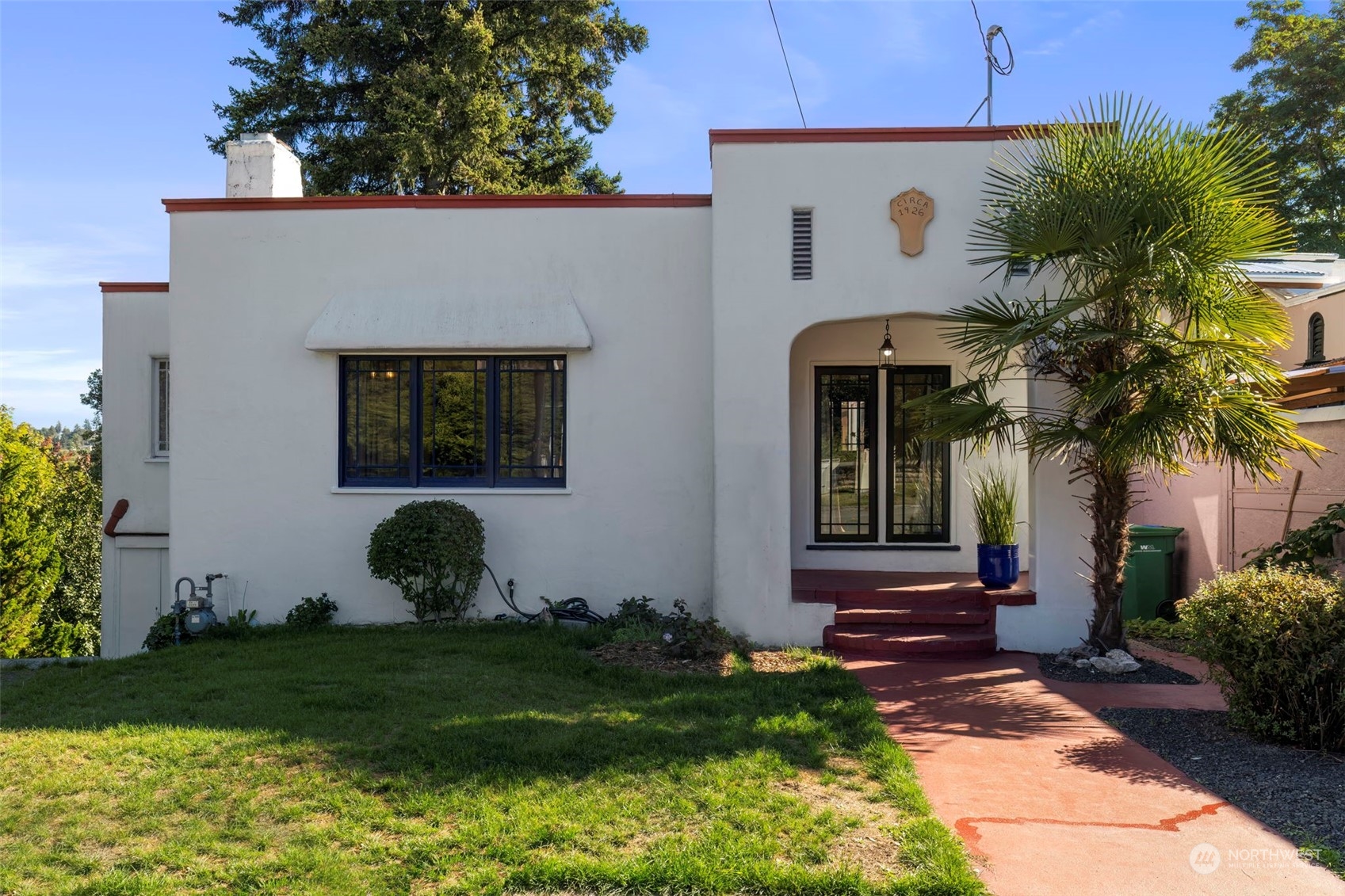 a front view of a house with garden