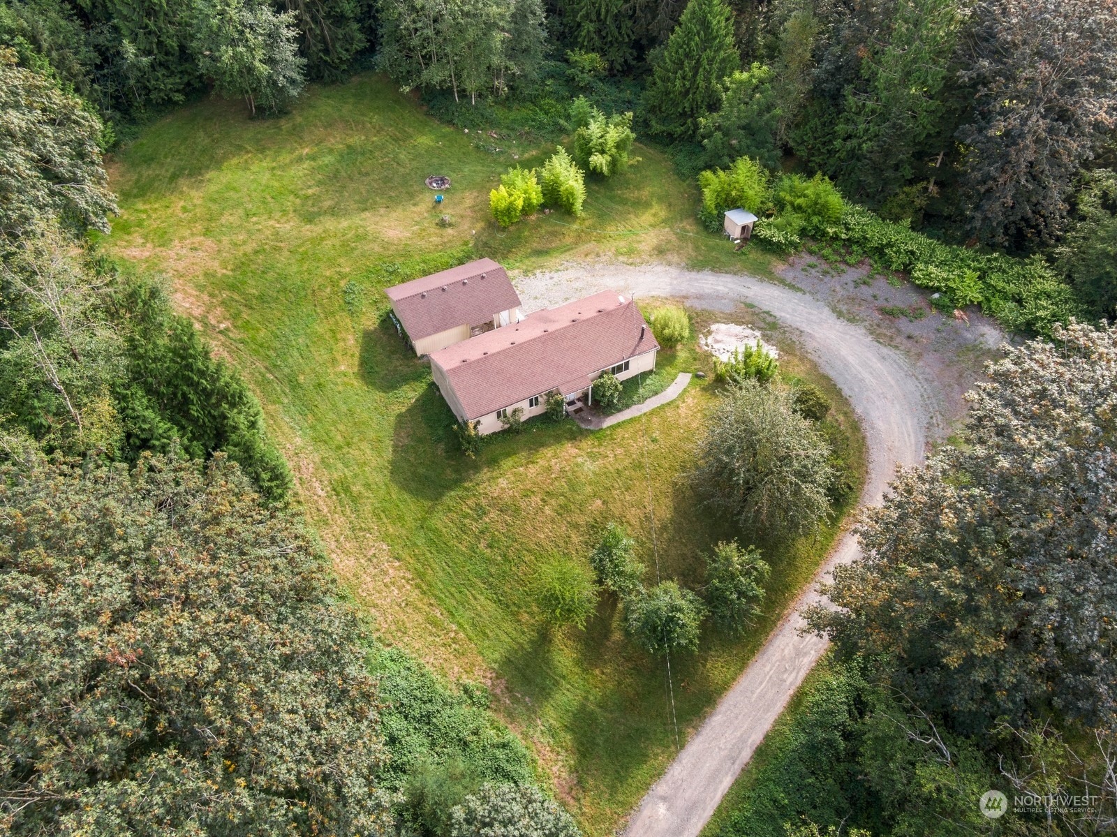 an aerial view of a house with a yard lake lake and green space