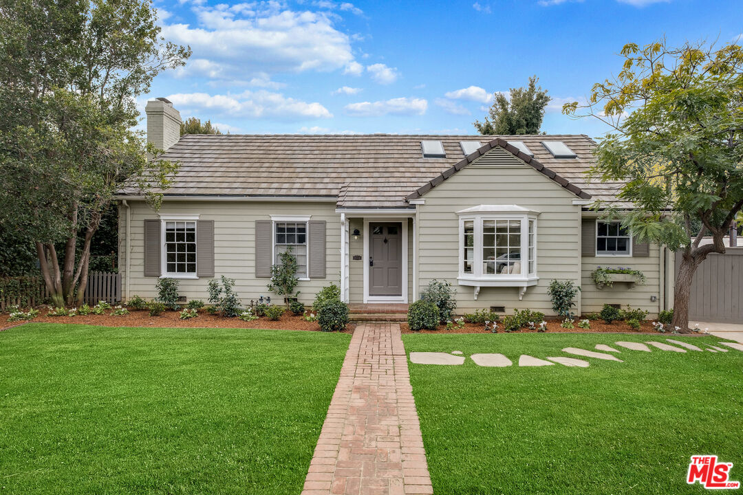 a front view of a house with a yard and porch