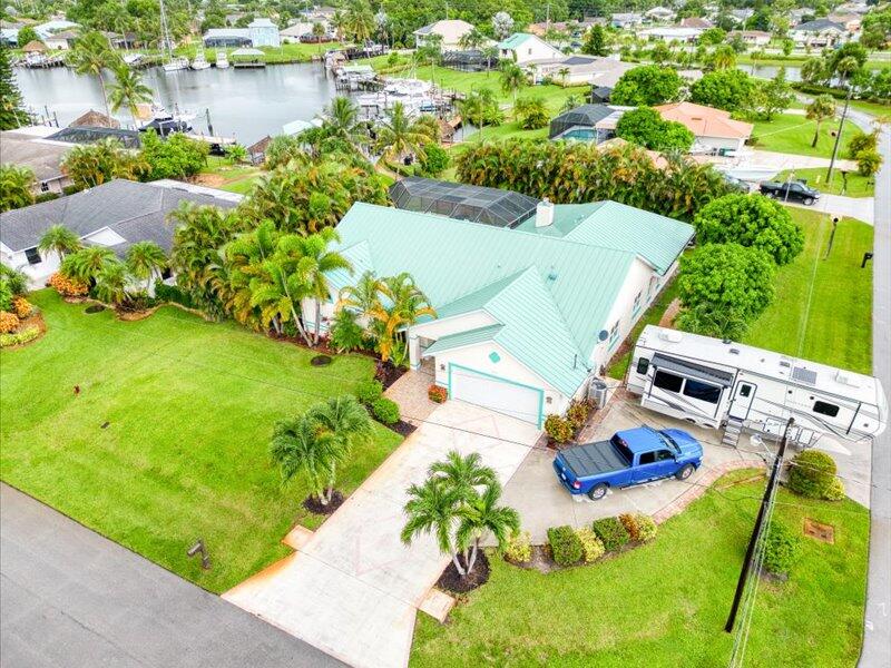 an aerial view of a house with a yard and lake view