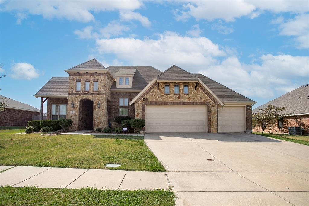 a front view of a house with a yard and garage