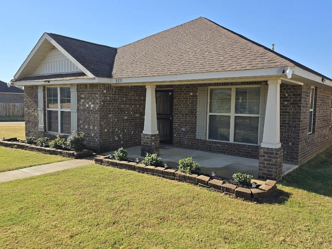 View of front of property featuring a front yard and a porch