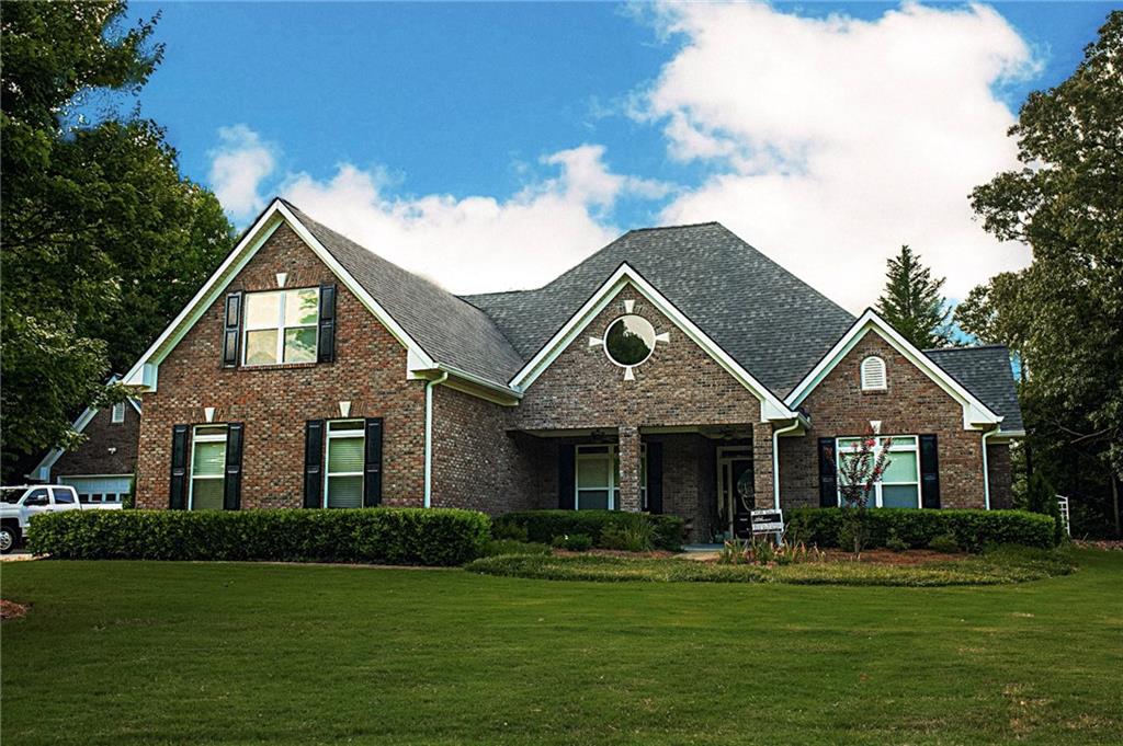 a front view of a house with a garden