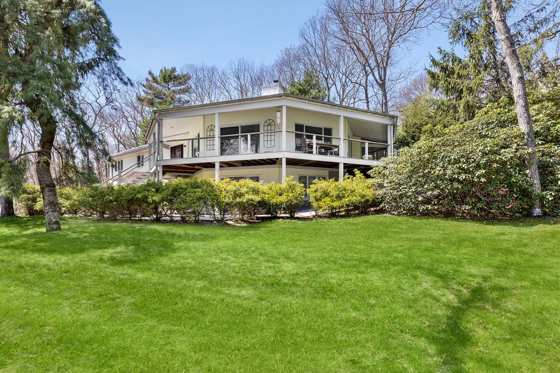 a front view of house with yard and trees