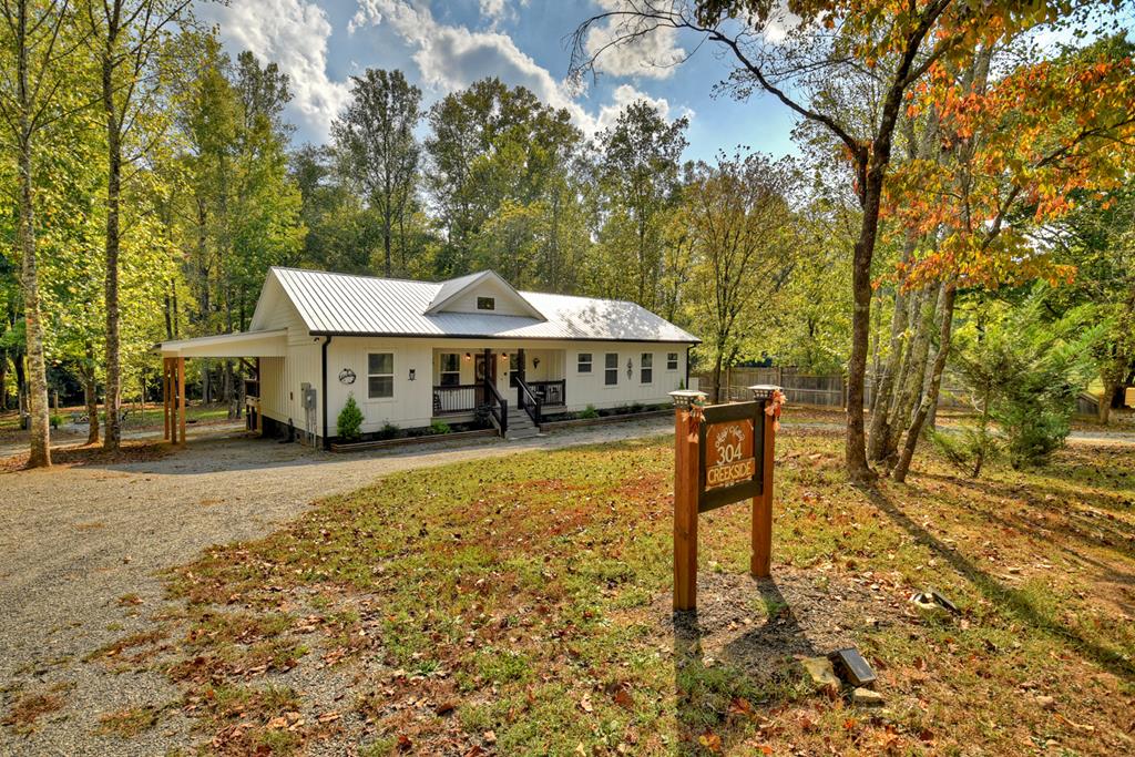 a view of a house with a yard and sitting area