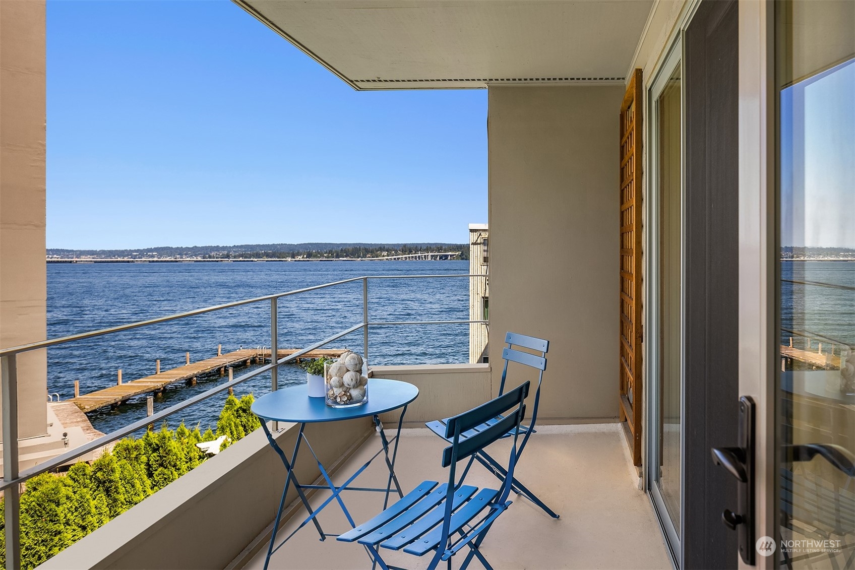 a balcony with table and chairs