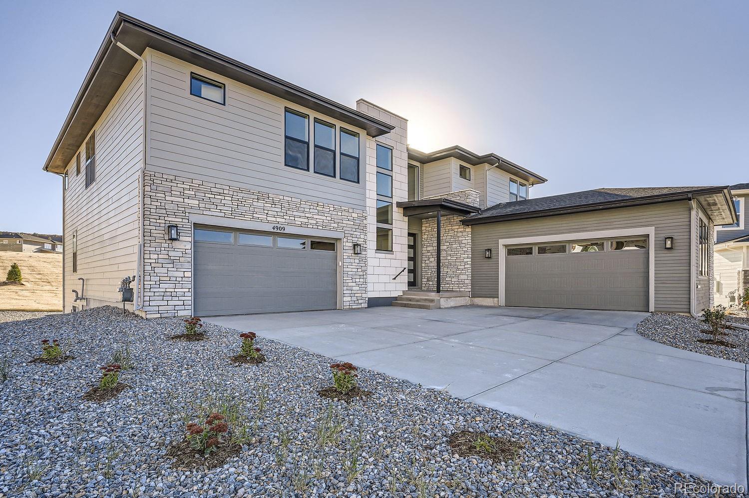 a front view of a house with yard and parking space