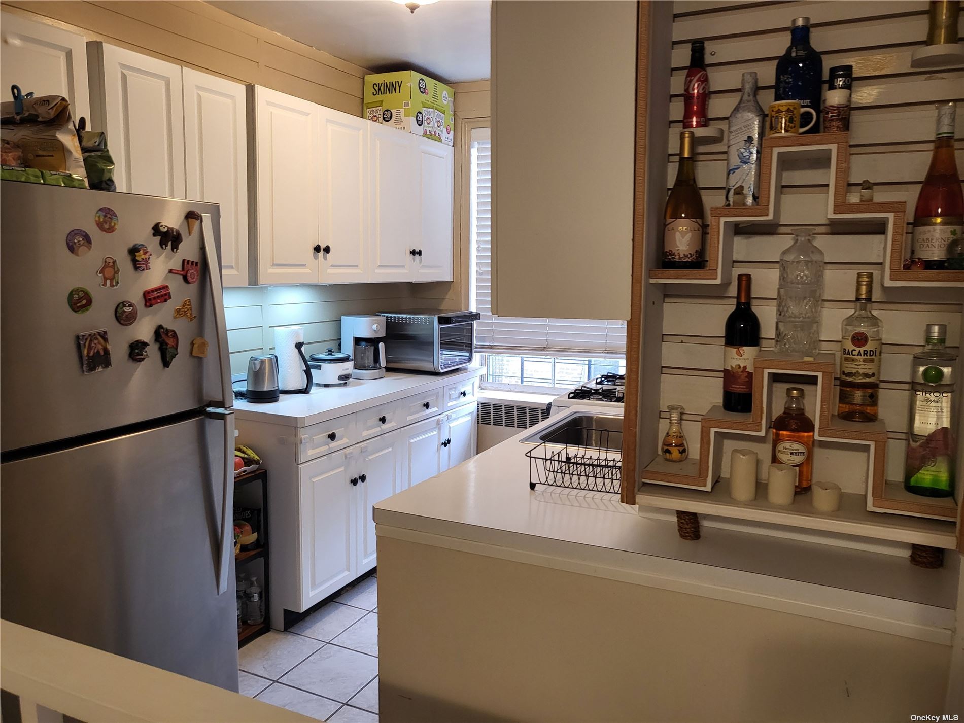 a kitchen with a refrigerator and a stove top oven