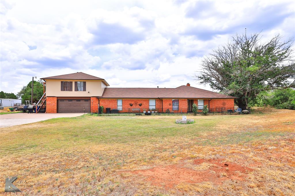 a view of a house with a yard and sitting area