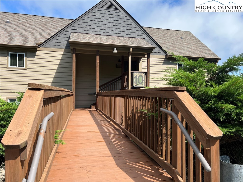 a view of a house with wooden deck