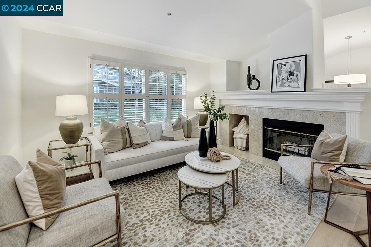 a living room with furniture a fireplace and a table