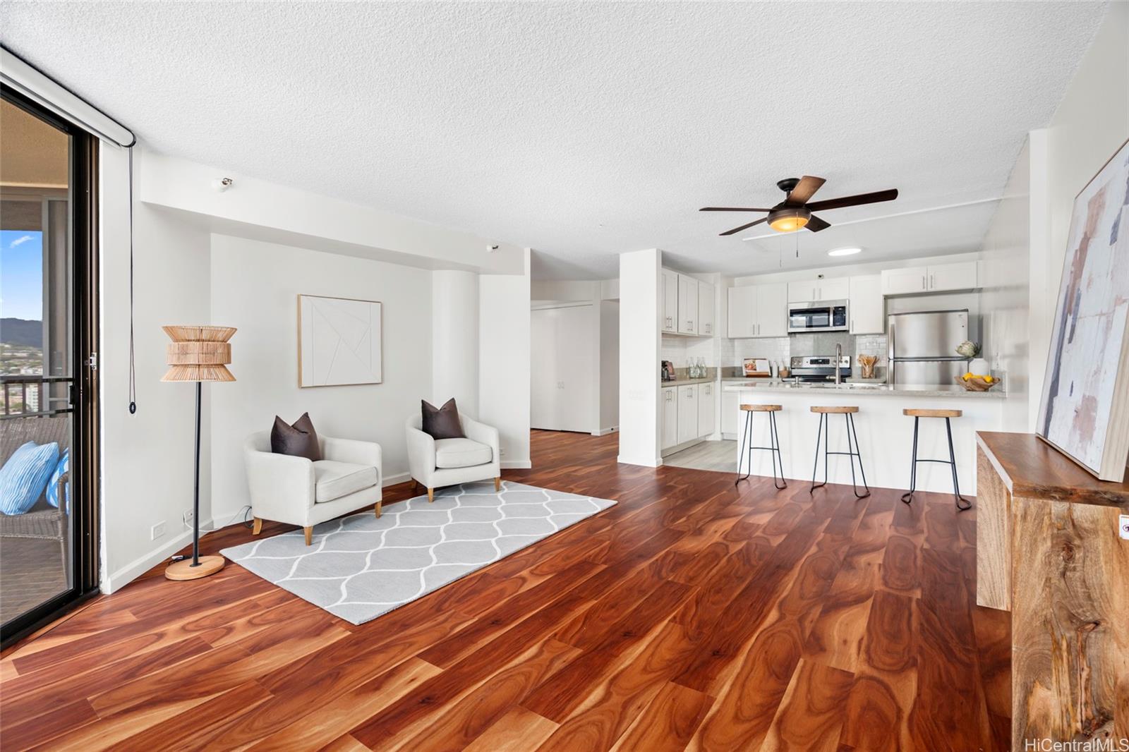 a living room with kitchen island furniture and a wooden floor