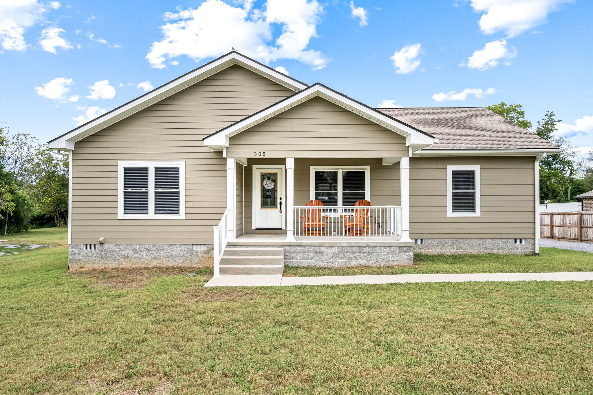 a front view of a house with a yard