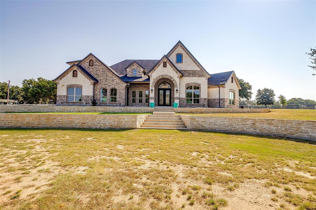 a front view of a house with a large pool and a yard