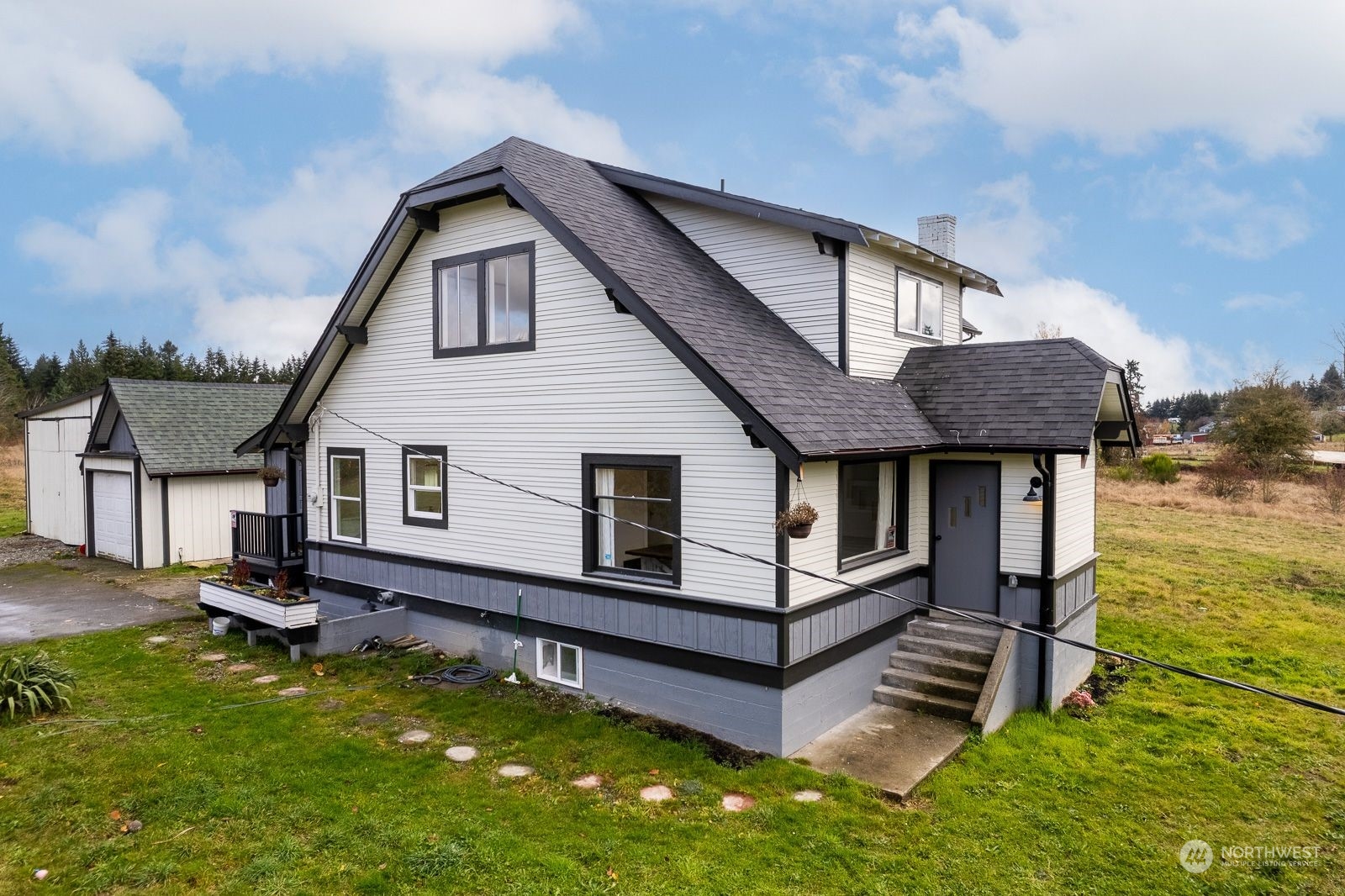 a front view of a house with yard and balcony