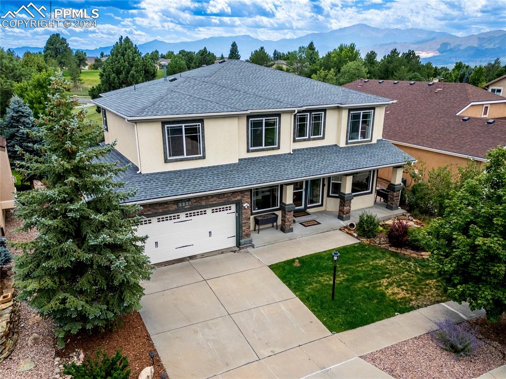 View of front of house featuring a mountain view and a garage