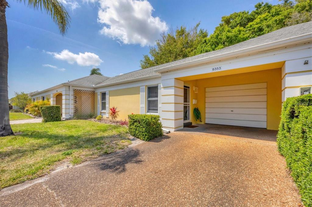 a view of a house with a yard and garage