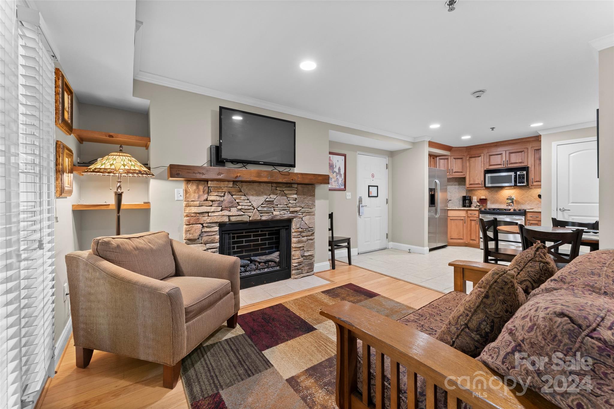 a living room with furniture fireplace and flat screen tv