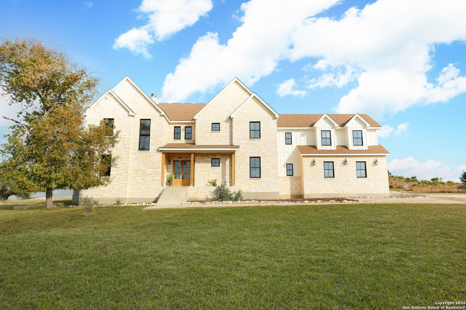 a front view of a house with a yard