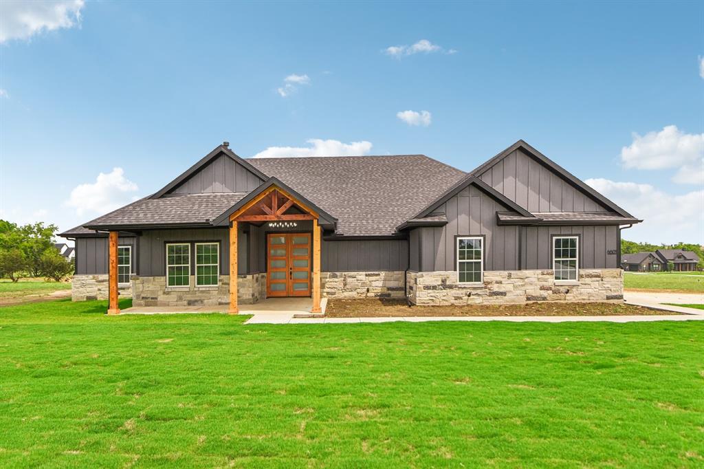 a front view of a house with a yard and patio