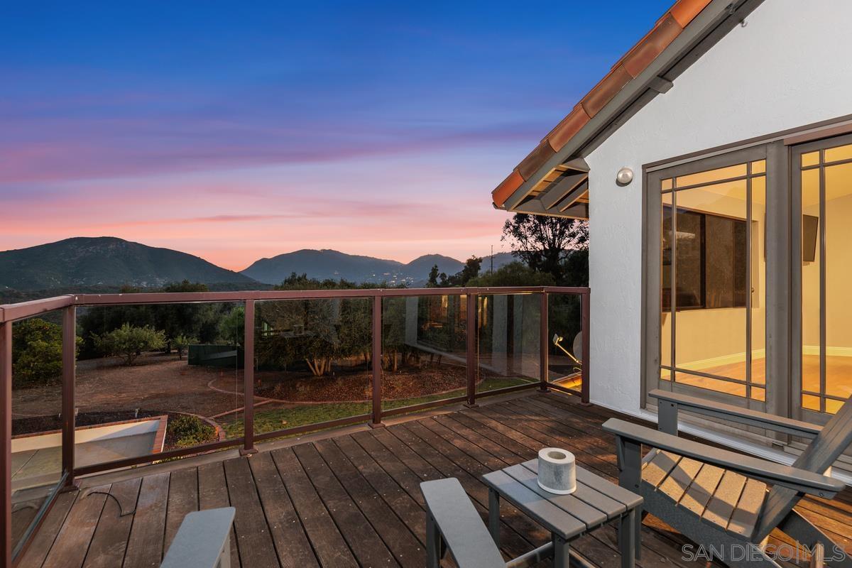 a view of a balcony with floor to ceiling windows with wooden floor