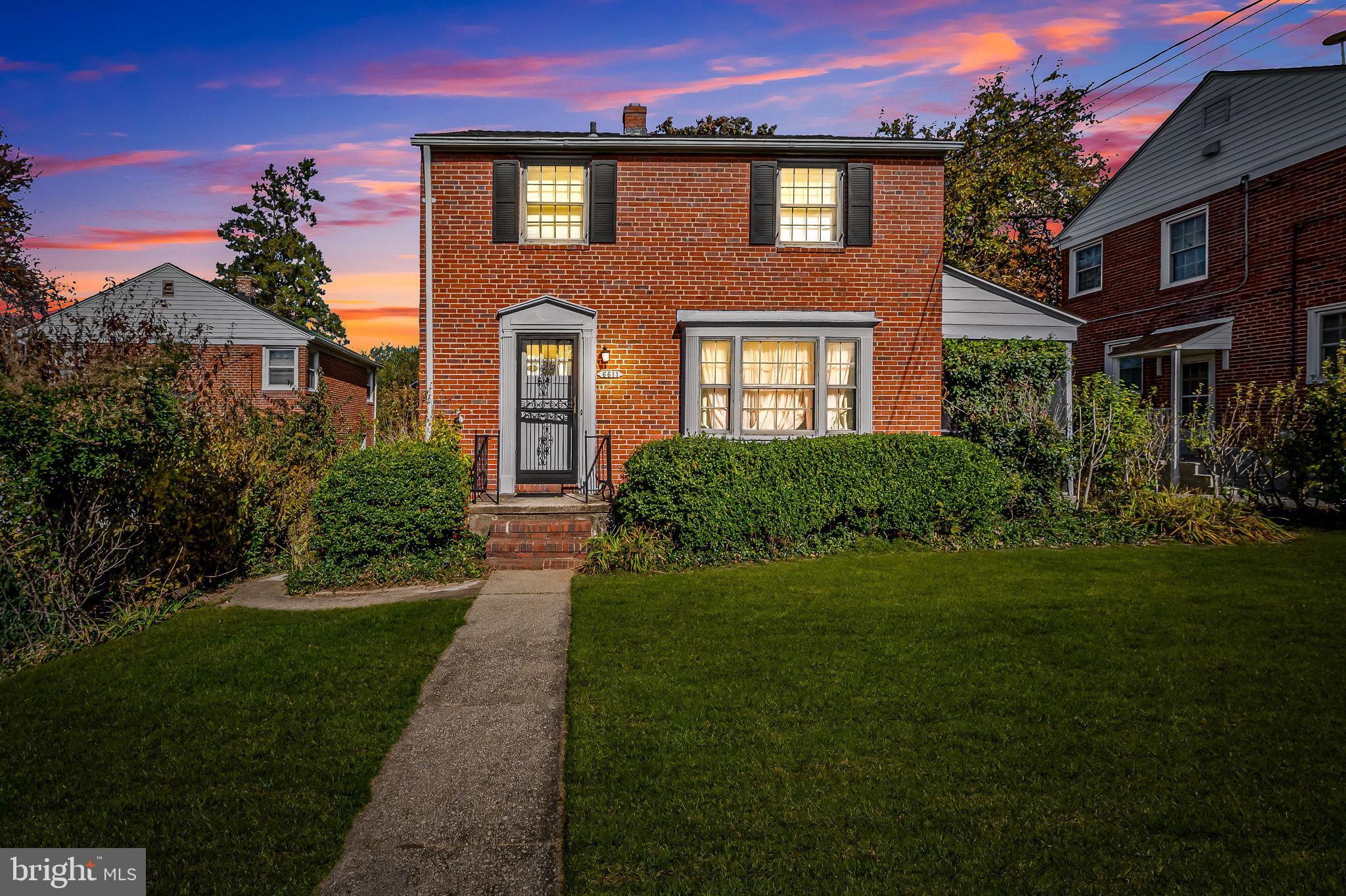 a front view of a house with a garden