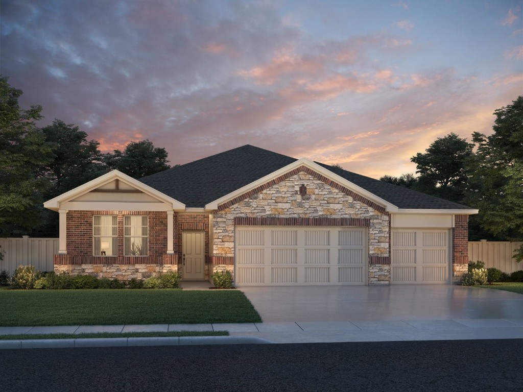 a front view of a house with a garden and garage