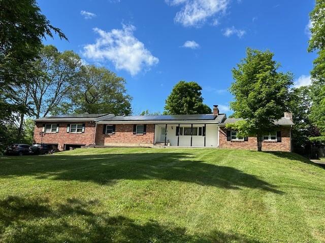 Front view of property with a lawn