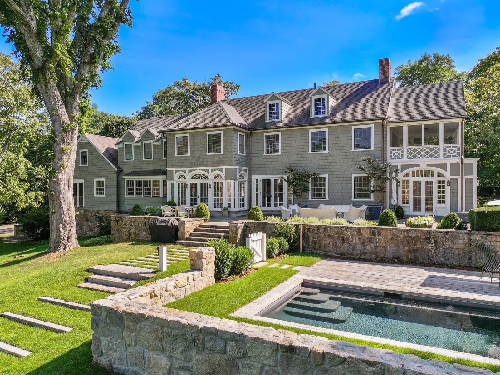 a front view of a house with swimming pool and porch