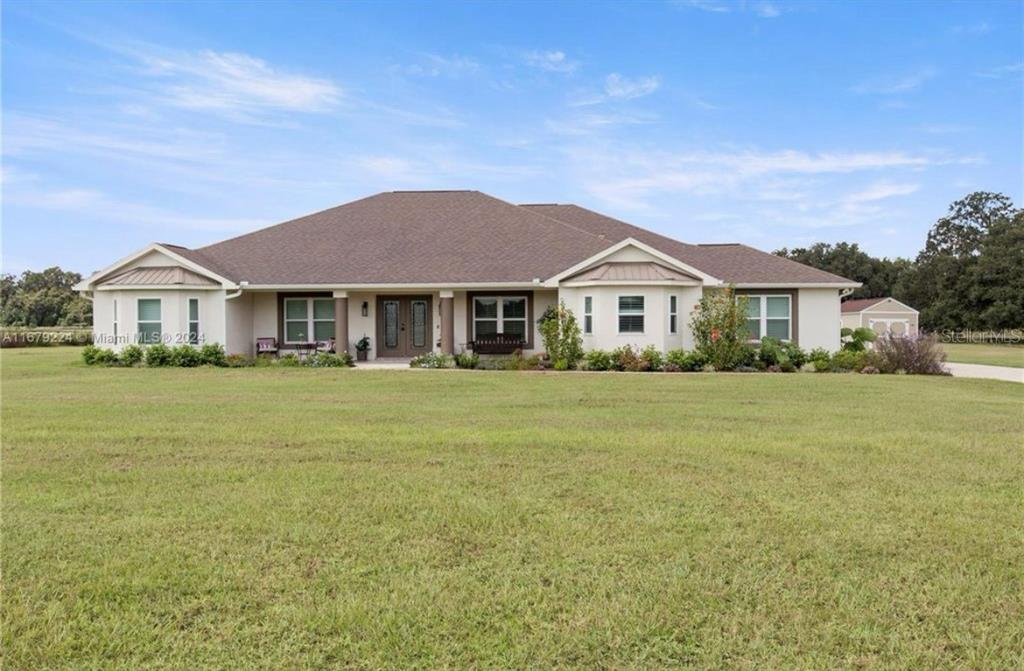 a front view of a house with a garden