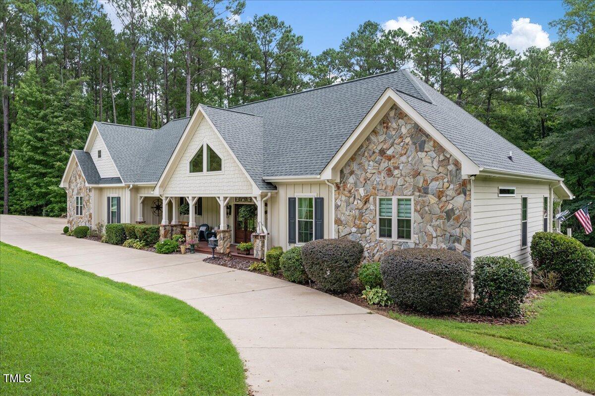 a view of a house with yard and green space