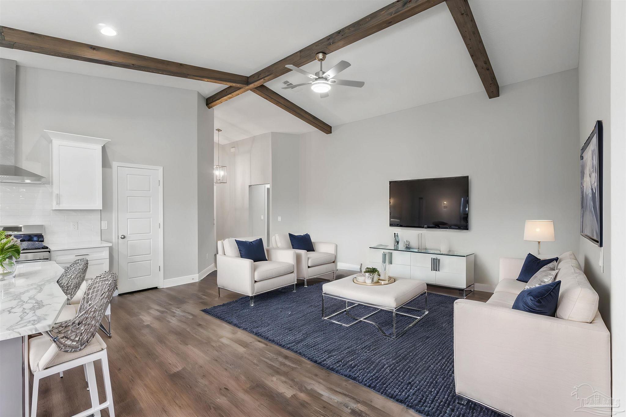 a living room with furniture and a flat screen tv