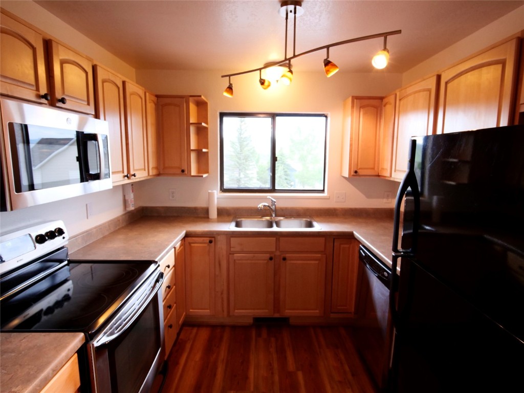 a kitchen with a sink stove and refrigerator