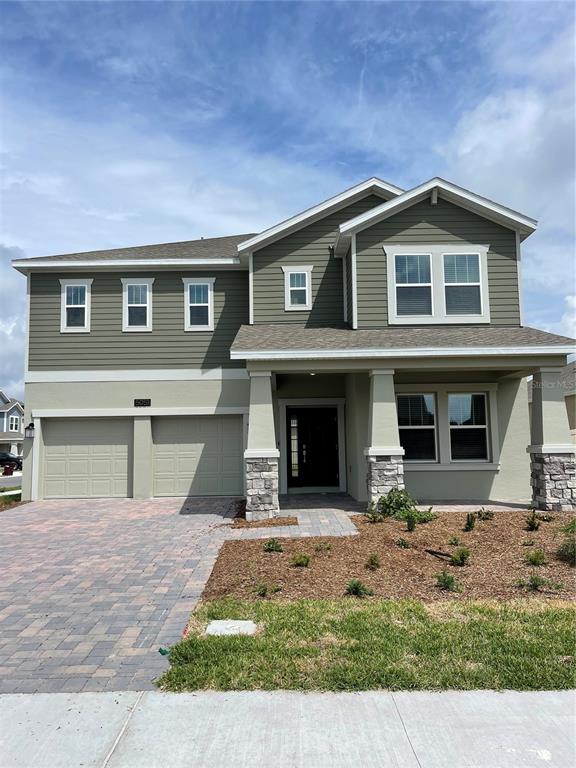 a front view of a house with garage and yard